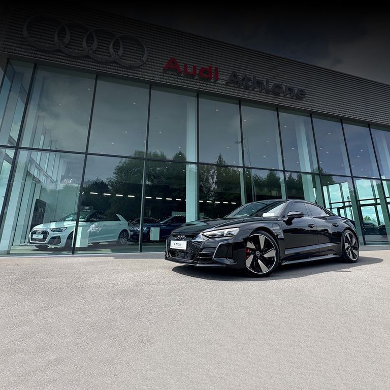An Audi e-tron GT parked outside of Audi Athlone dealership.